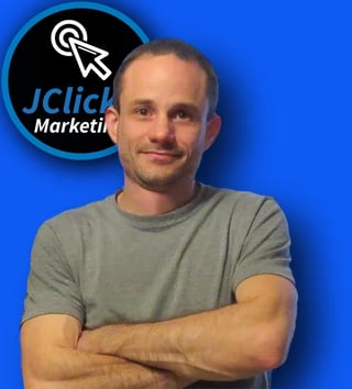 Man in gray t-shirt with arms crossed standing in front of blue background with Jclick Marketing logo